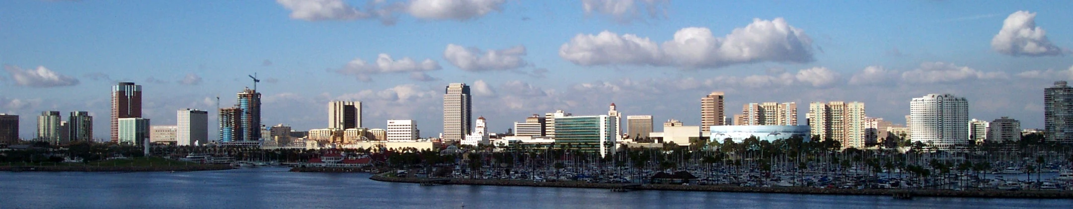 Daytime panorama of the Long Beach skyline and waterfront beneath a blue sky